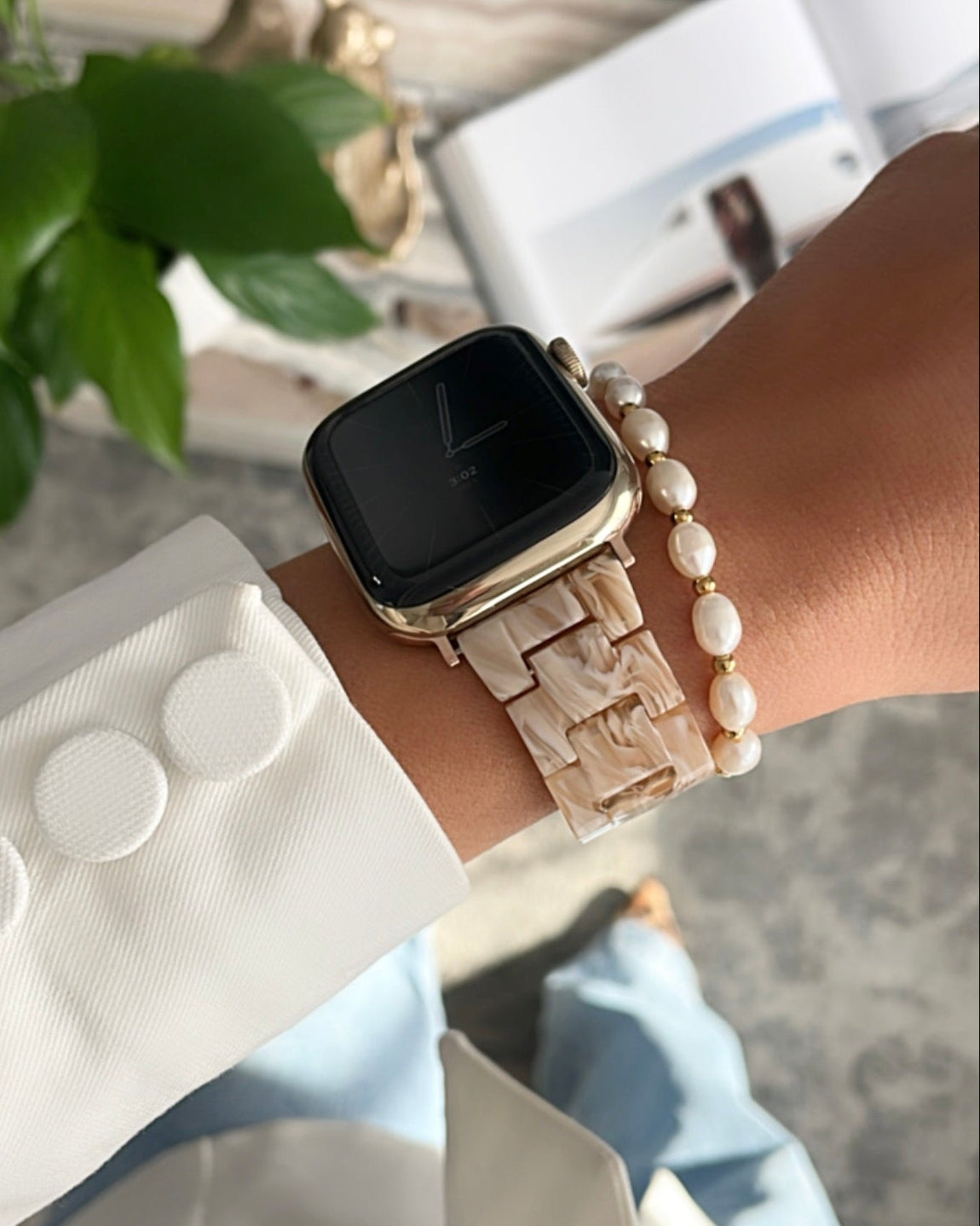 Smartwatch with a decorative band on a wrist, blurred background