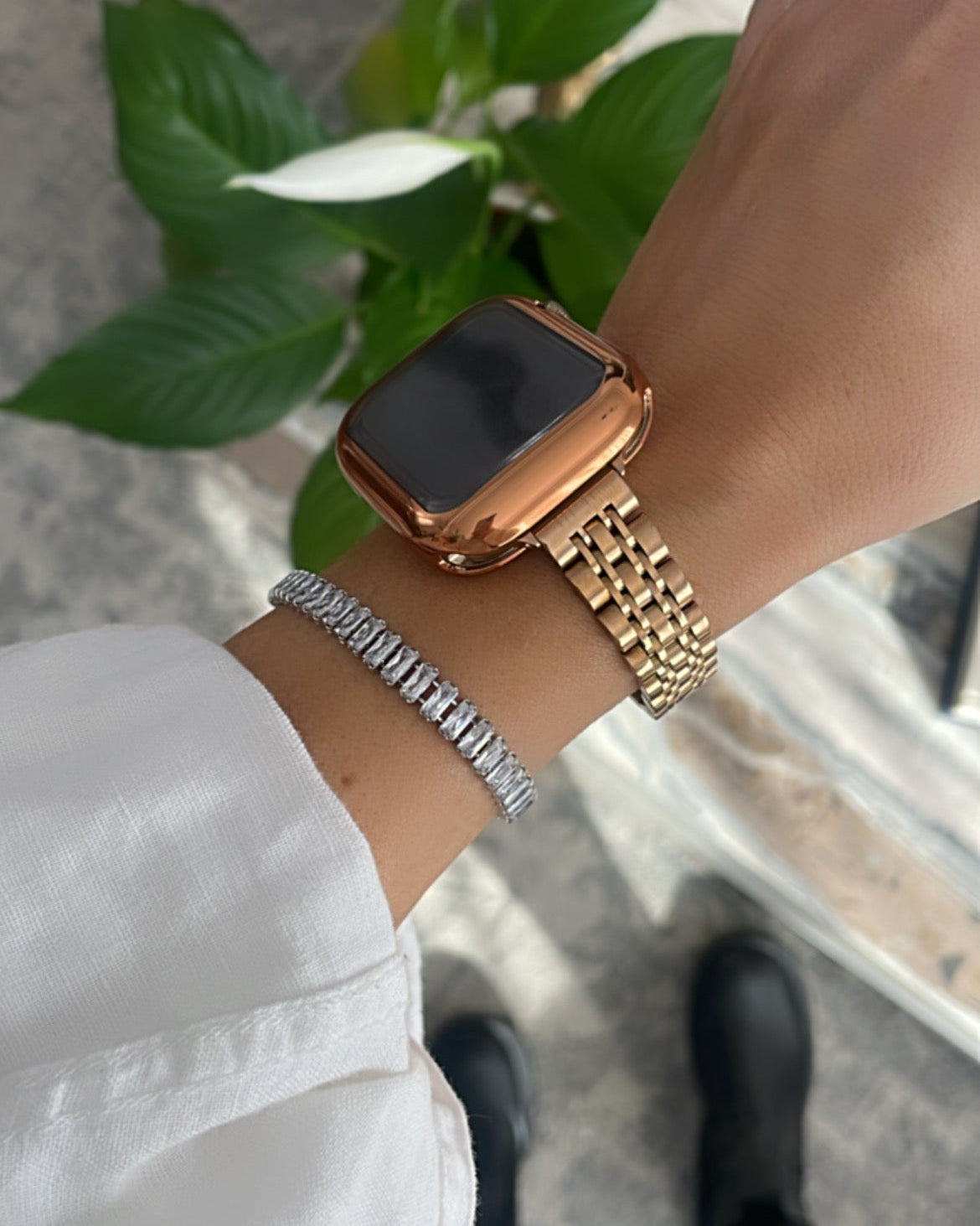Gold watch on a wrist with a blurred background