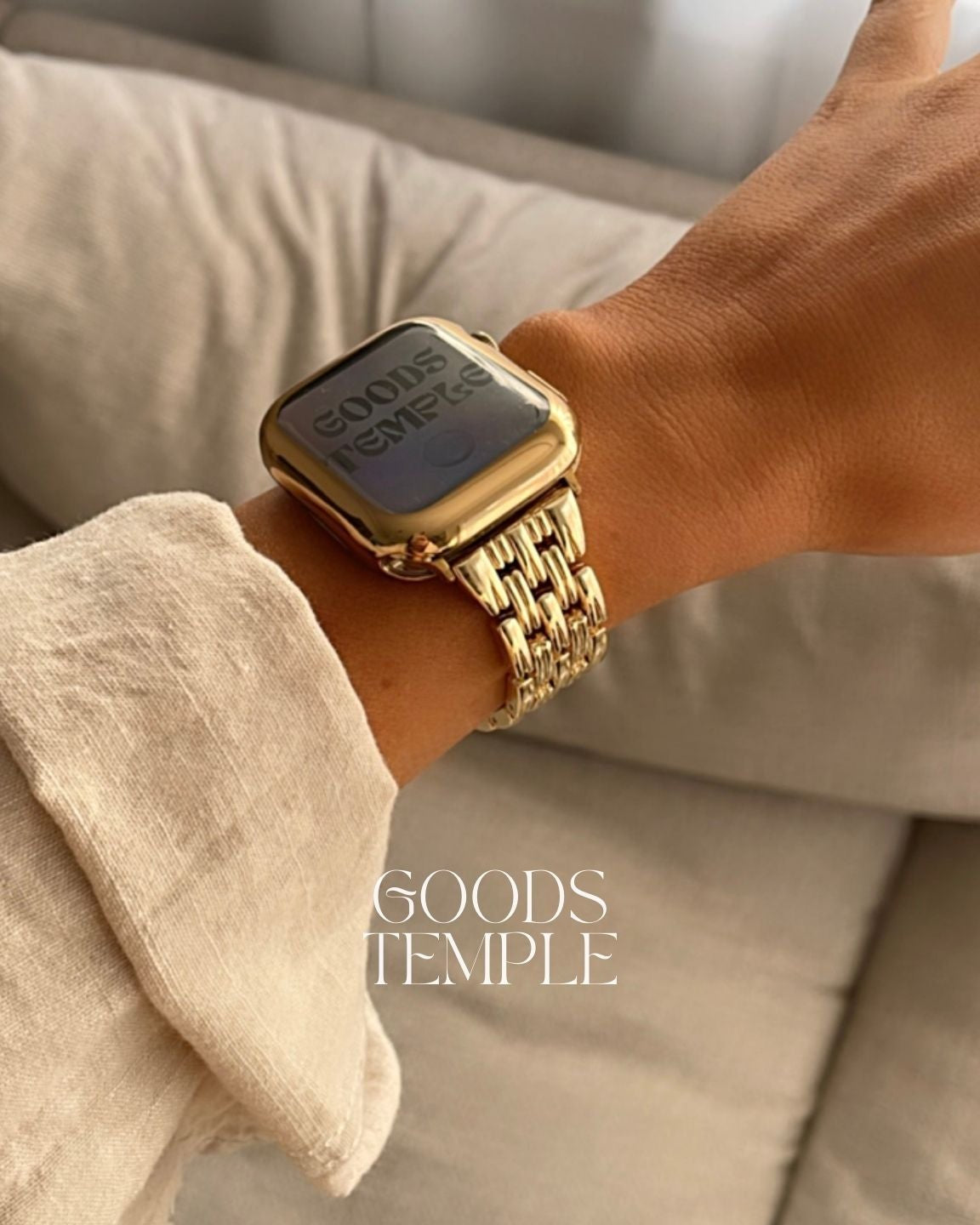 Gold watch on a wrist with 'GOODS TEMPLE' branding.