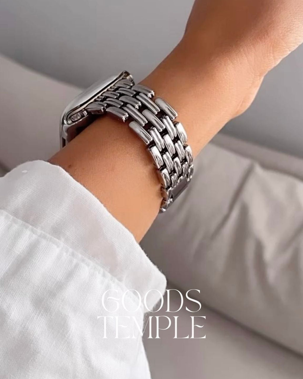 Silver chain bracelet on a wrist with a blurred background