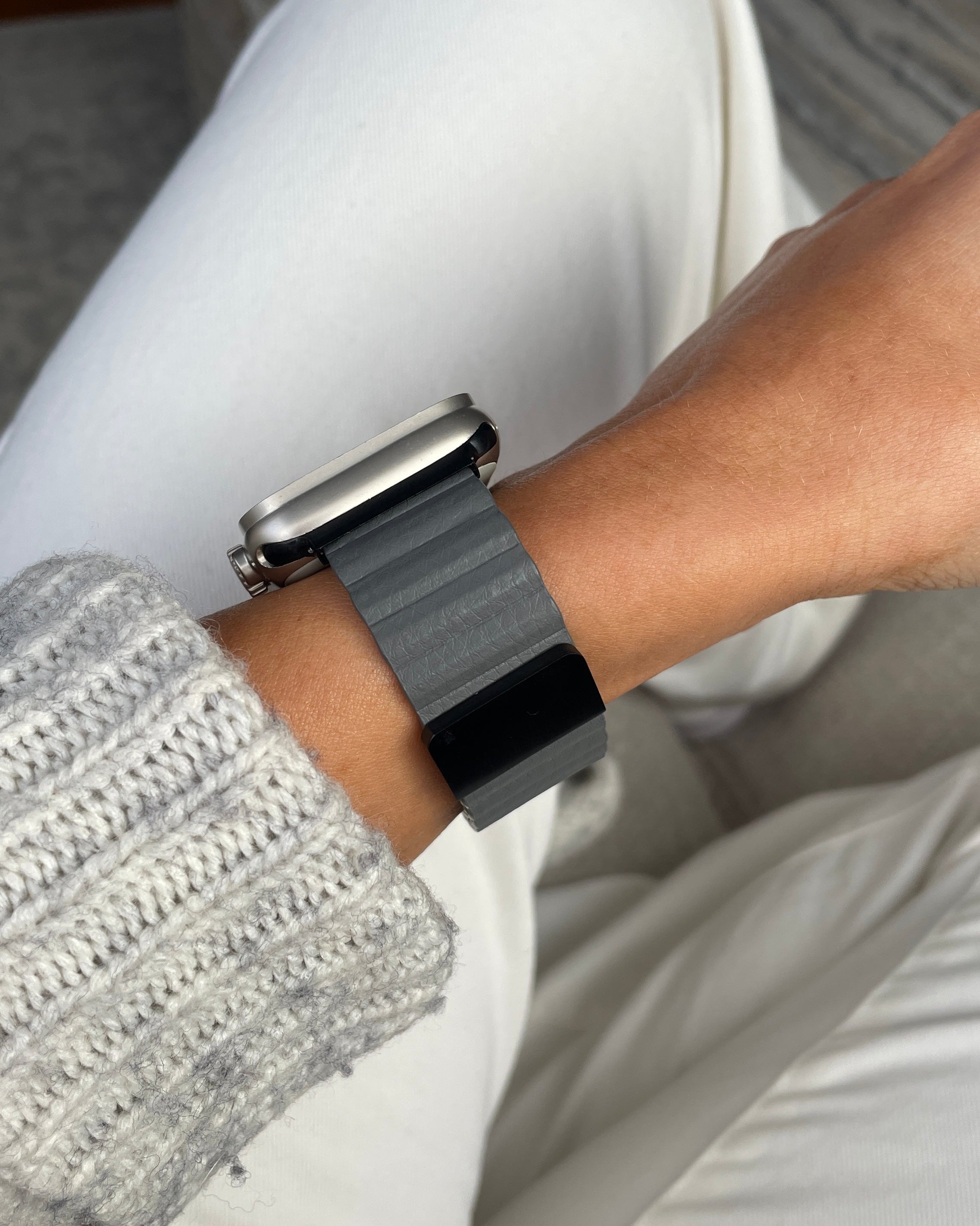 Person wearing a smartwatch with a focus on the wrist and hand.