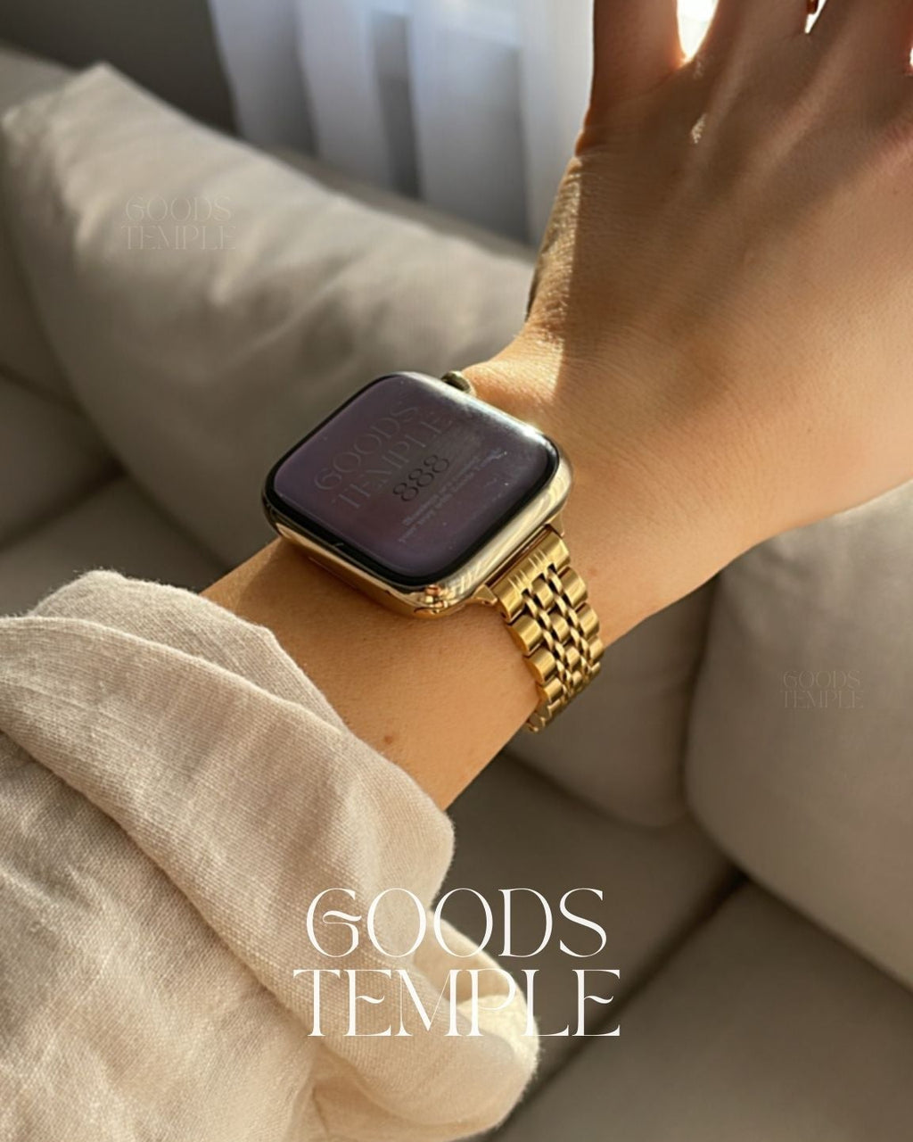 Hand wearing a gold smartwatch on a neutral background with 'GOODS TEMPLE' branding.