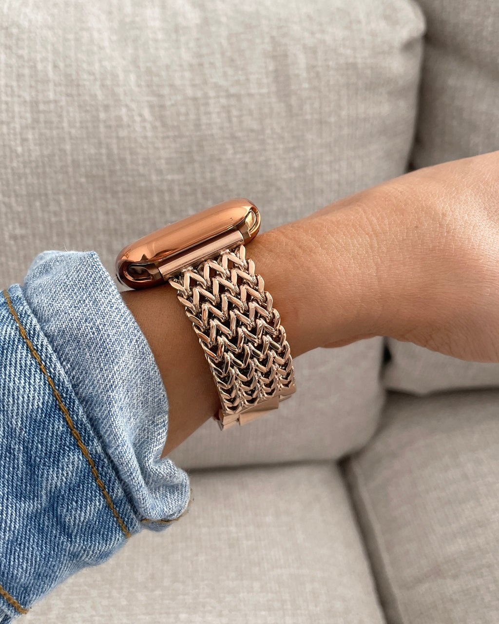 Rose gold bracelet on a wrist with a light background