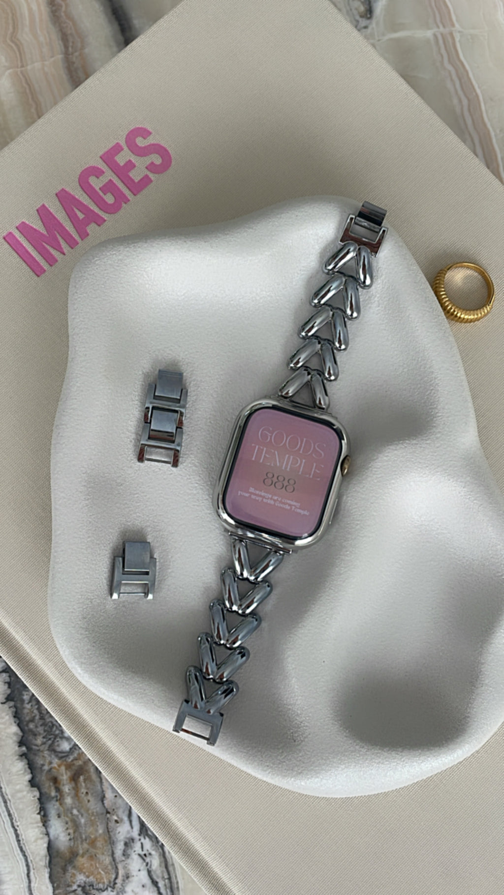 Smartwatch with a chain strap on a white stand with 'IMAGES' text.