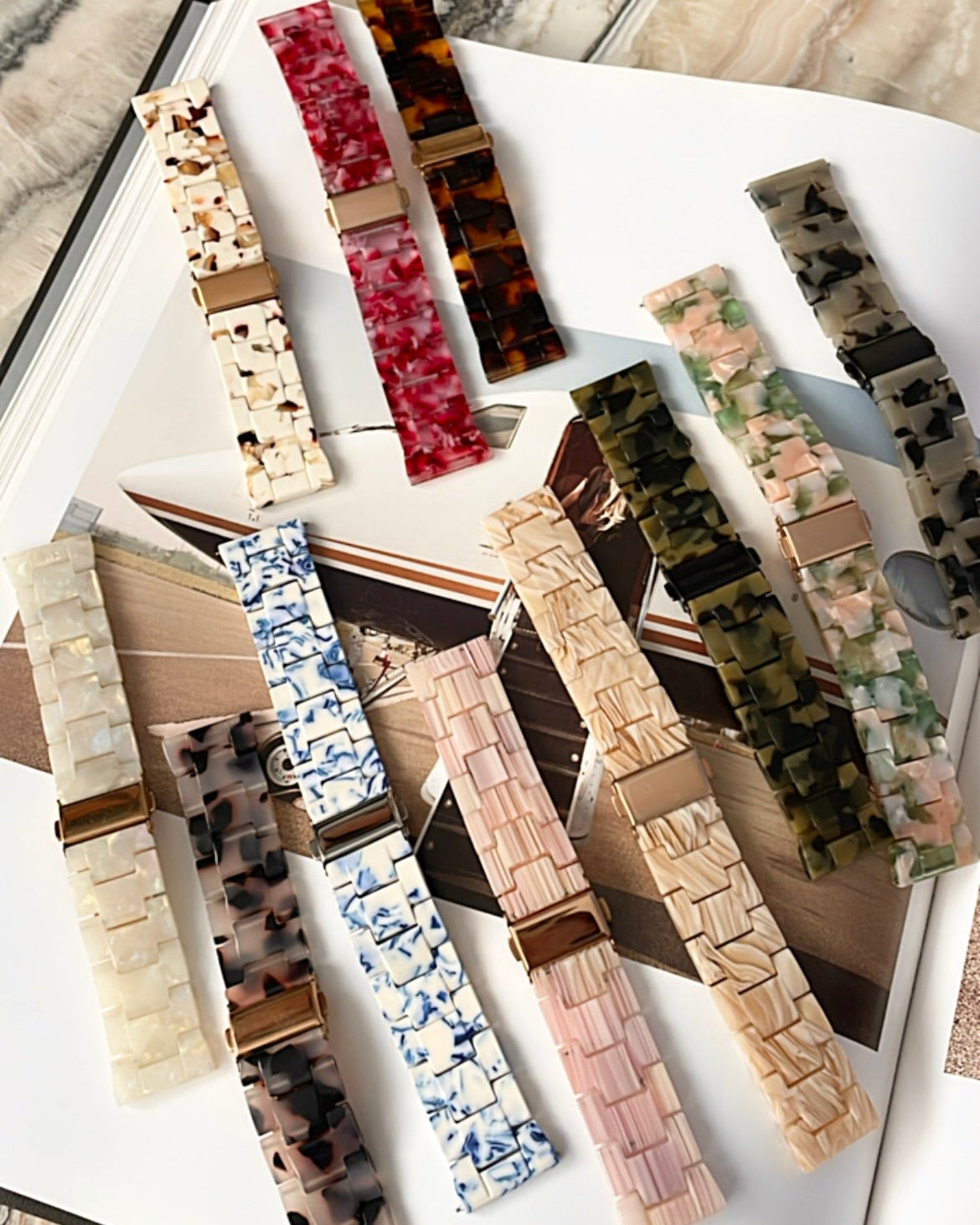 Collection of various watch straps on a marble surface