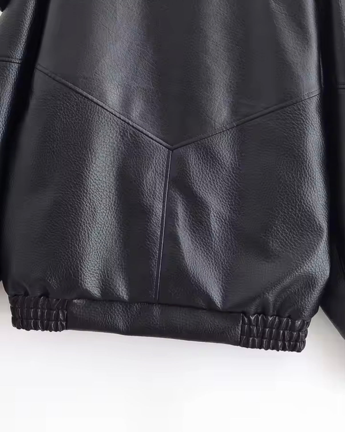 Close-up of a black leather jacket on a white background
