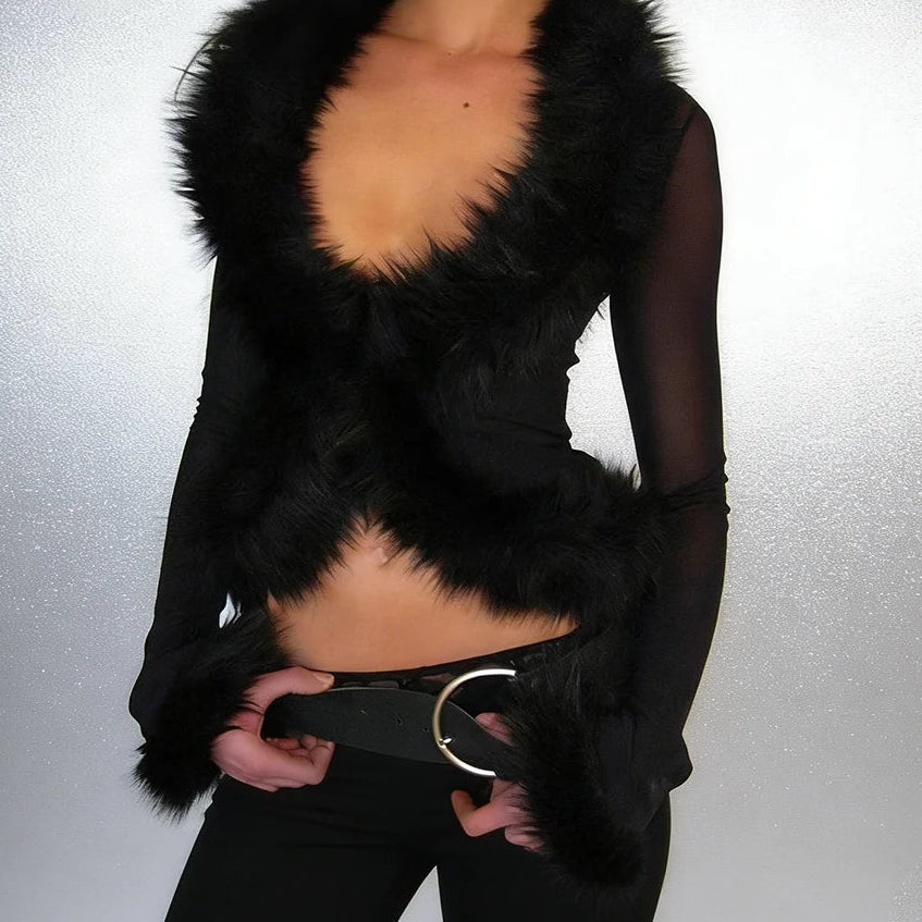 Black fur-trimmed outfit with a blurred background