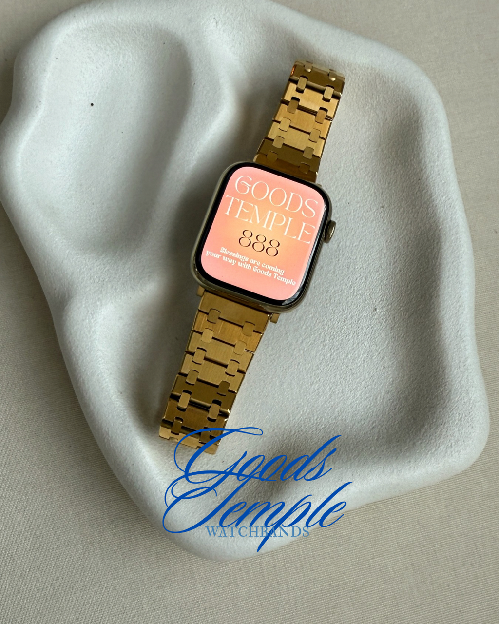 Gold watch with a digital display on a textured surface, featuring 'Goods Temple' branding.