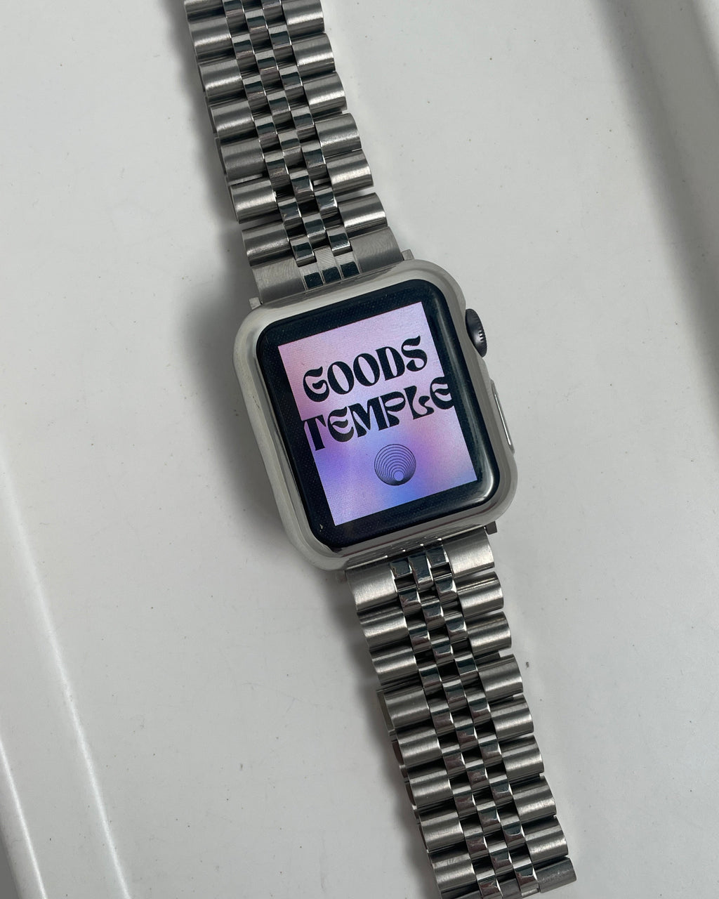 Silver watch with digital display on a white background