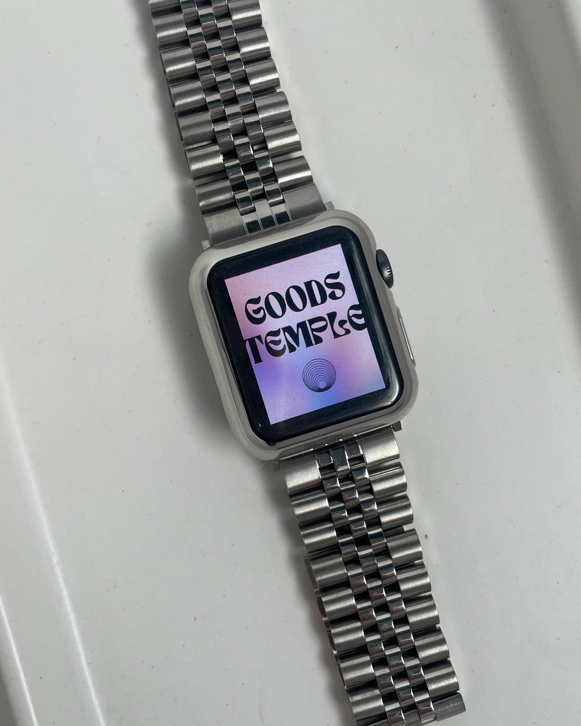 Silver watch with digital display on a white background
