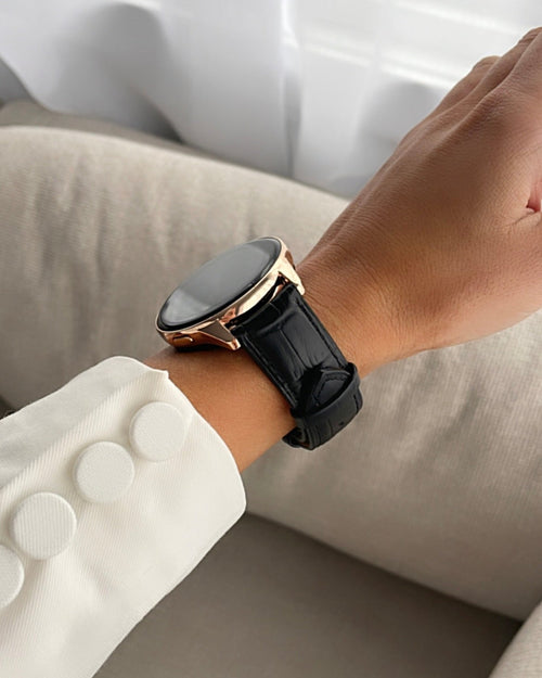 Smartwatch with a black strap on a wrist, blurred background
