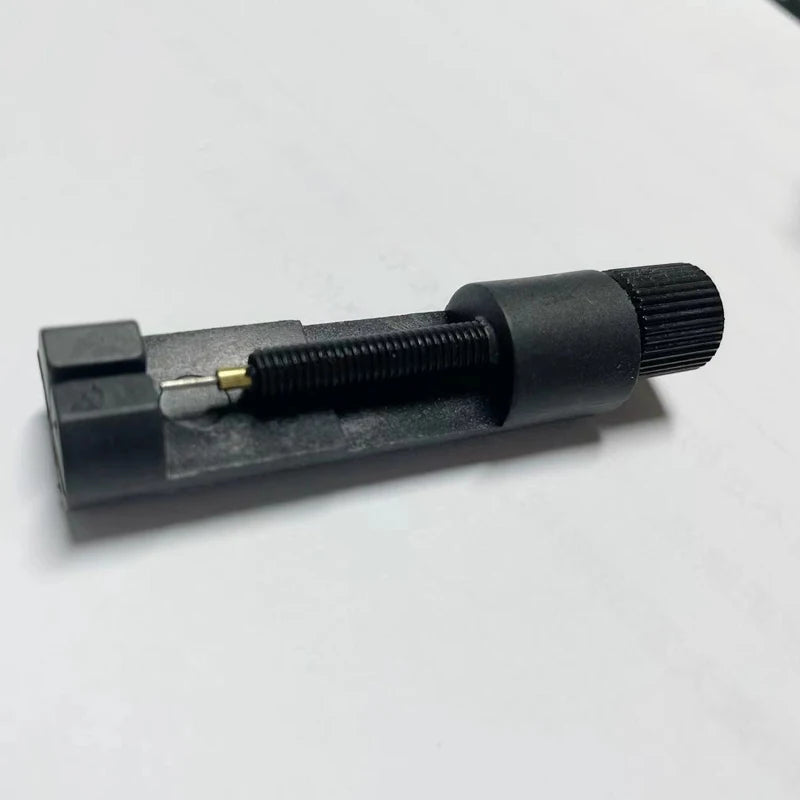 Black tool with a cylindrical design on a white background