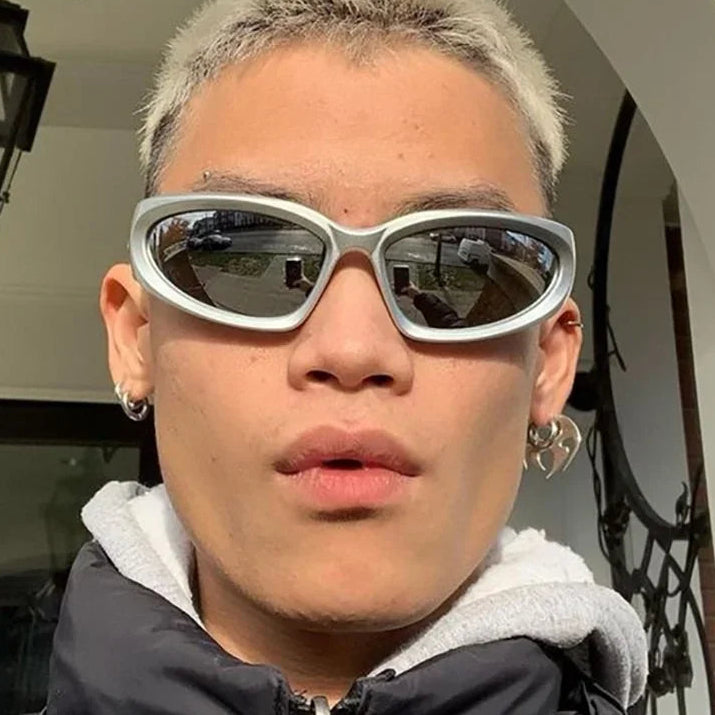 Person wearing large sunglasses with a neutral background
