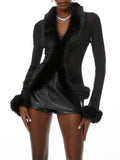 Black fur-trimmed coat worn by a model on a white background