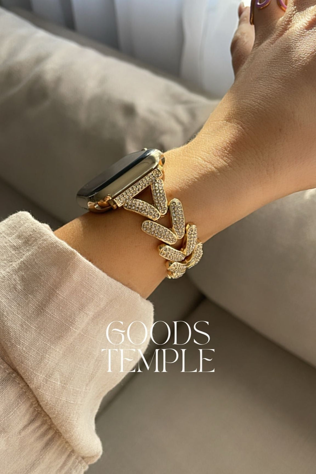 Gold bracelet on a wrist with 'Goods Temple' branding.