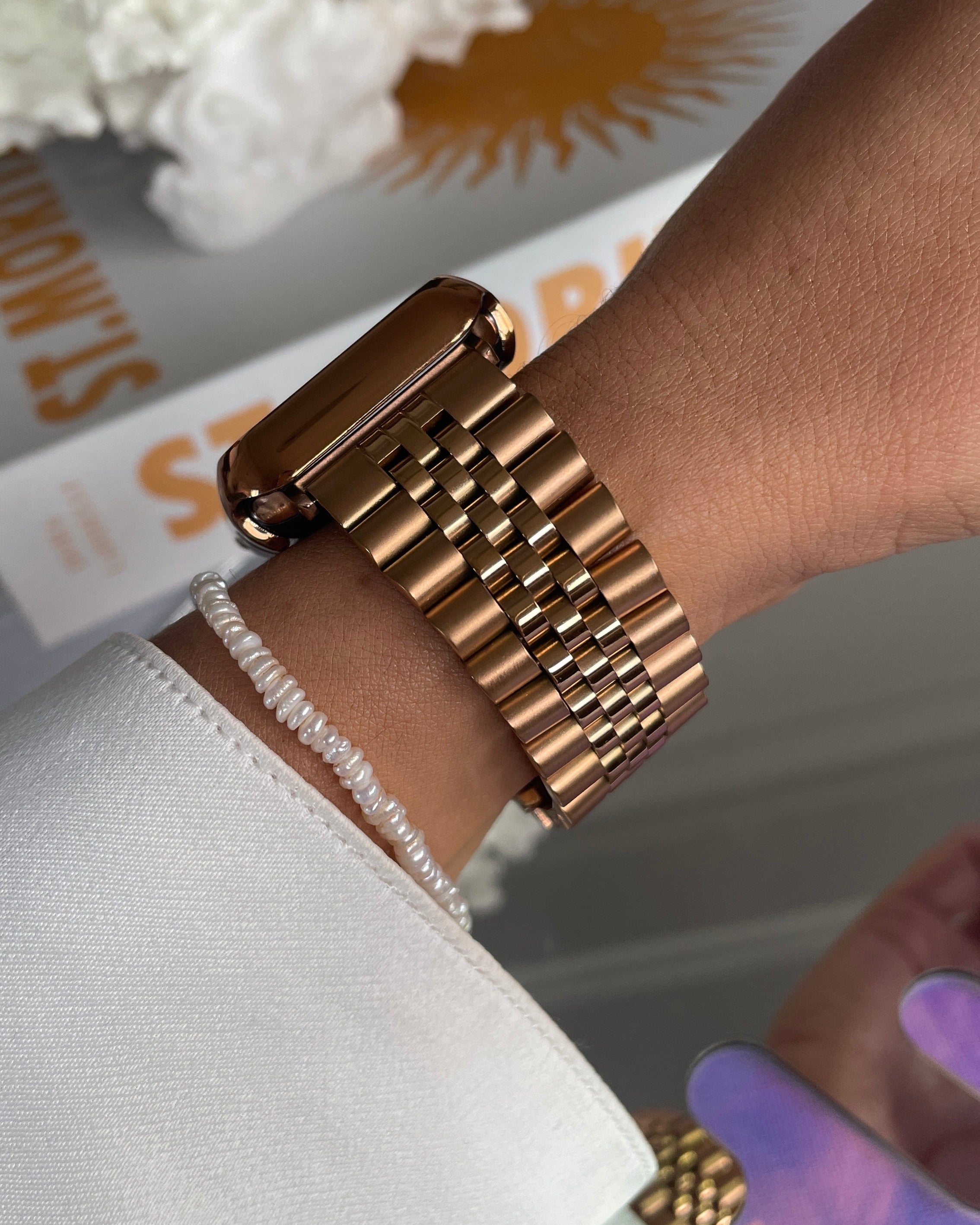 Gold bracelet on a wrist with a blurred background