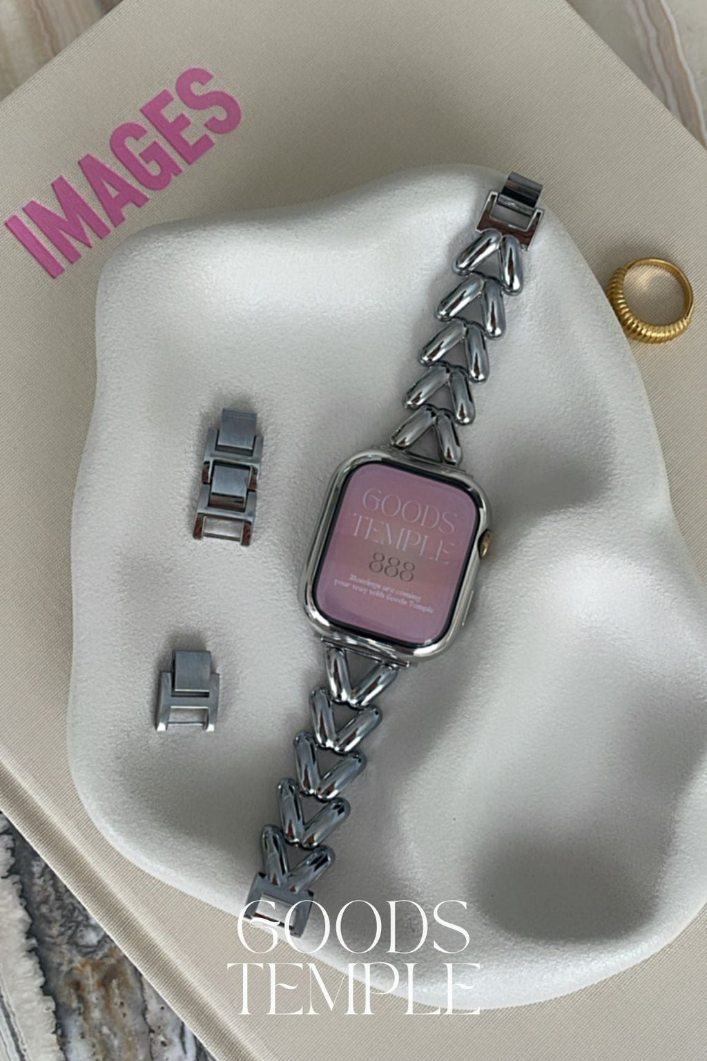 Smartwatch with chain strap on a white stand, branded 'GOODS TEMPLE'.