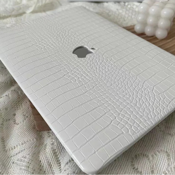 White textured laptop case on a light fabric background
